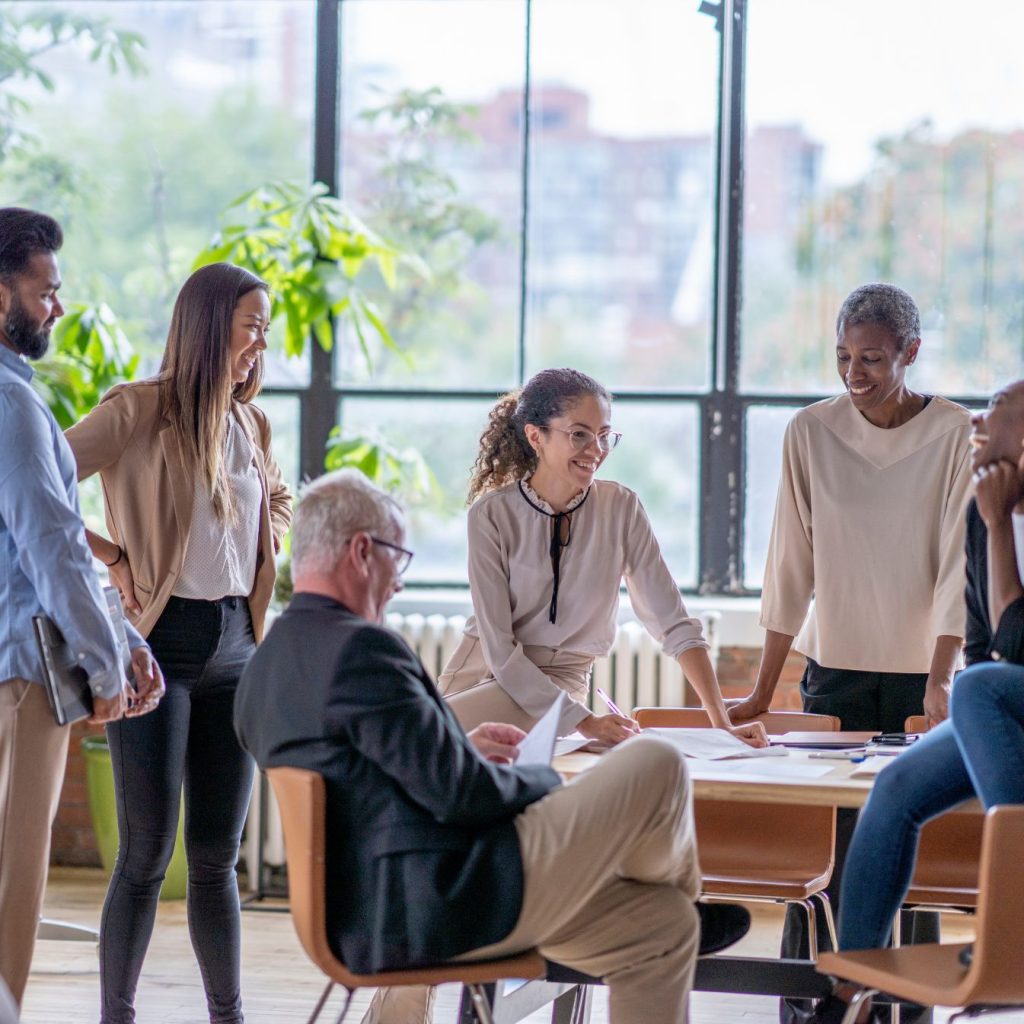 equipe pluridisciplinaire en réunion collaborative dans un espace lumineux, illustrant une approche de conseil humaine, personnalisée et fondée sur la co-construction.