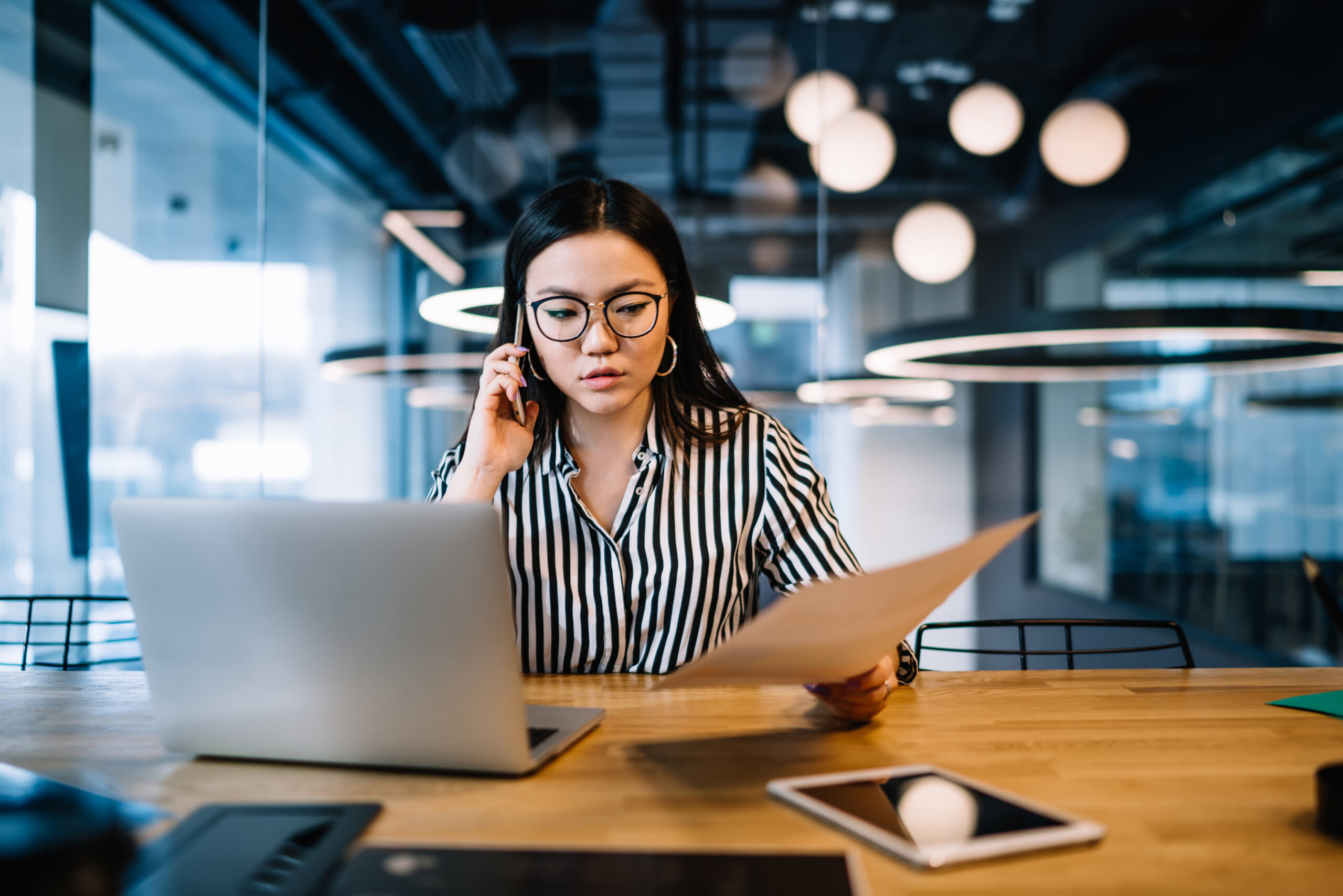 Professionnelle analysant des documents pour assurer une veille légale et conventionnelle